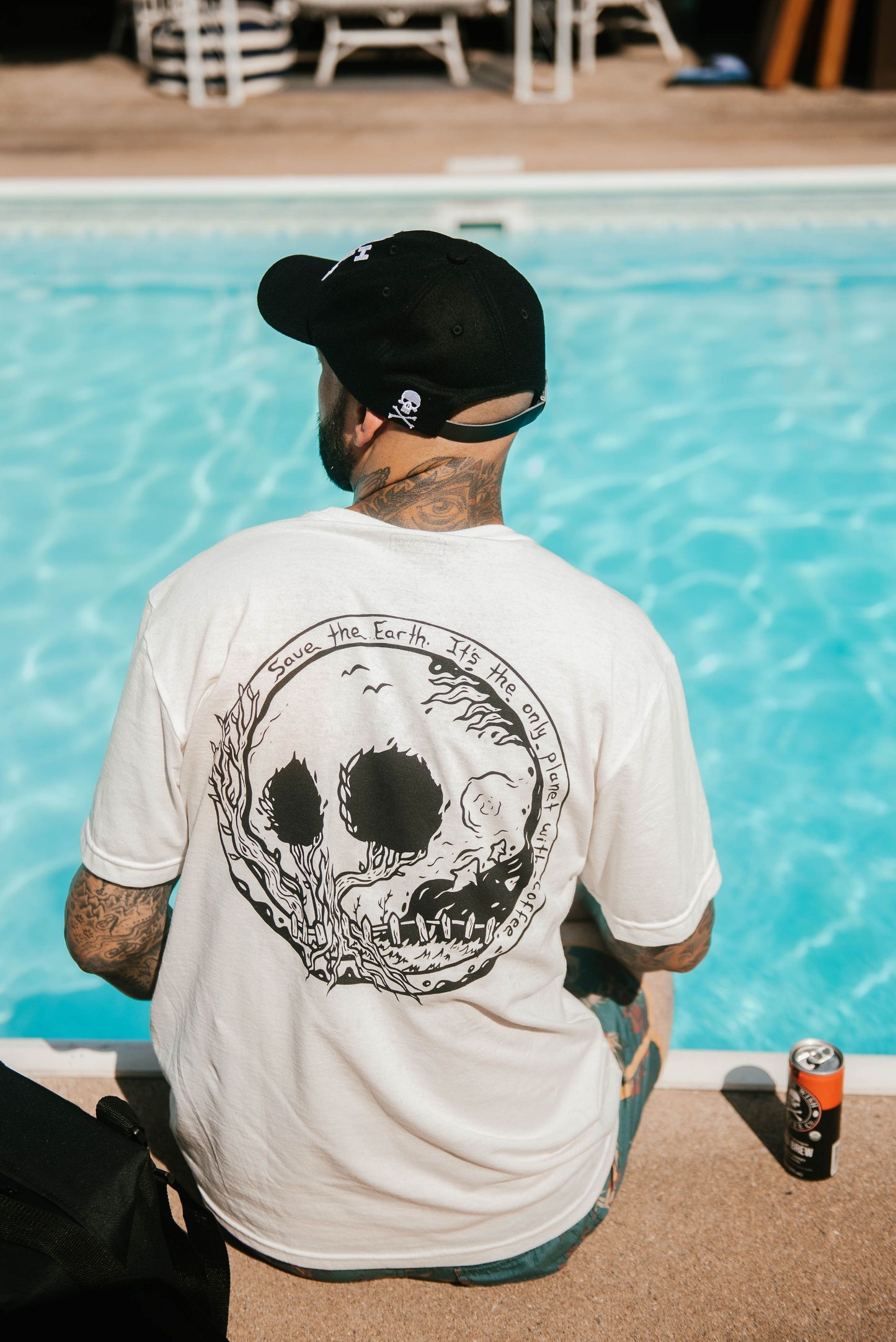 Back view of man wearing white Save the Planet Earth Day Shirt