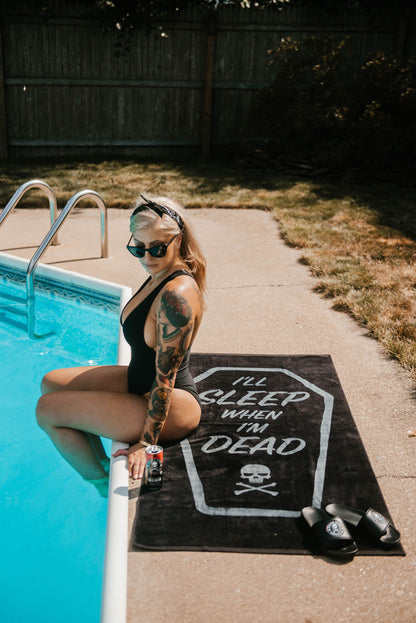 Woman sitting on I'll Sleep When I'm Dead Beach Towel