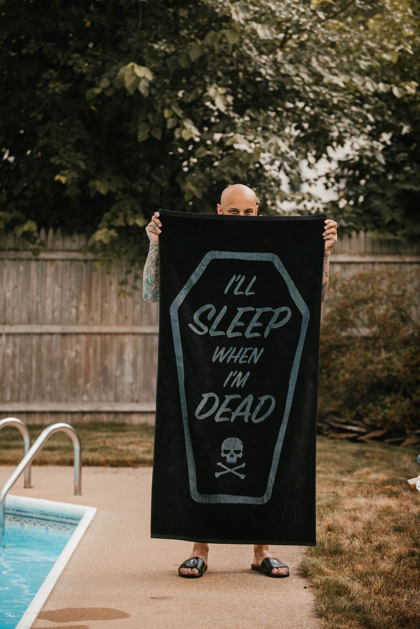 Man holding Death Wish beach towel