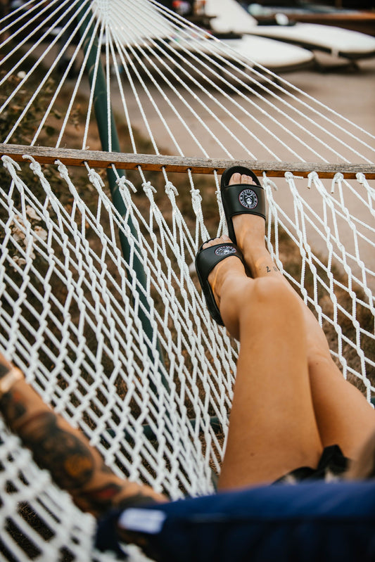 Woman wearing Death Wish Coffee Premium Slides