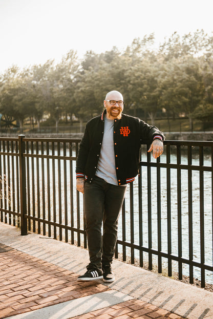 Full shot of man wearing Death Wish Letterman Jacket