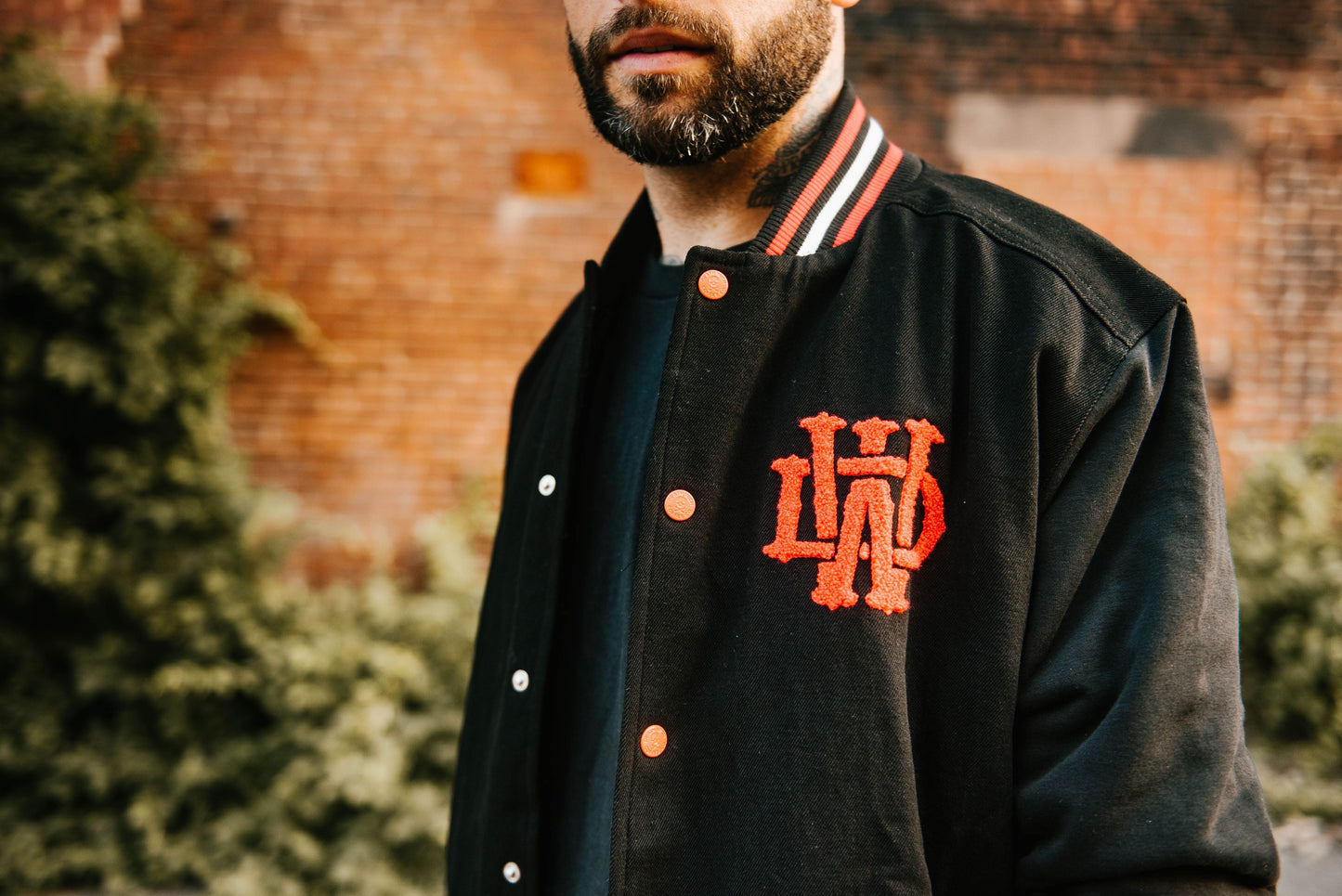 Man wearing Death Wish Letterman Jacket